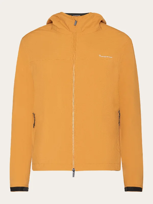 Men's safari jacket-Men's sporty exercise t-shirt-NORDENVIND™ Light shell jacket - GRS/Vegan - Golden yellow